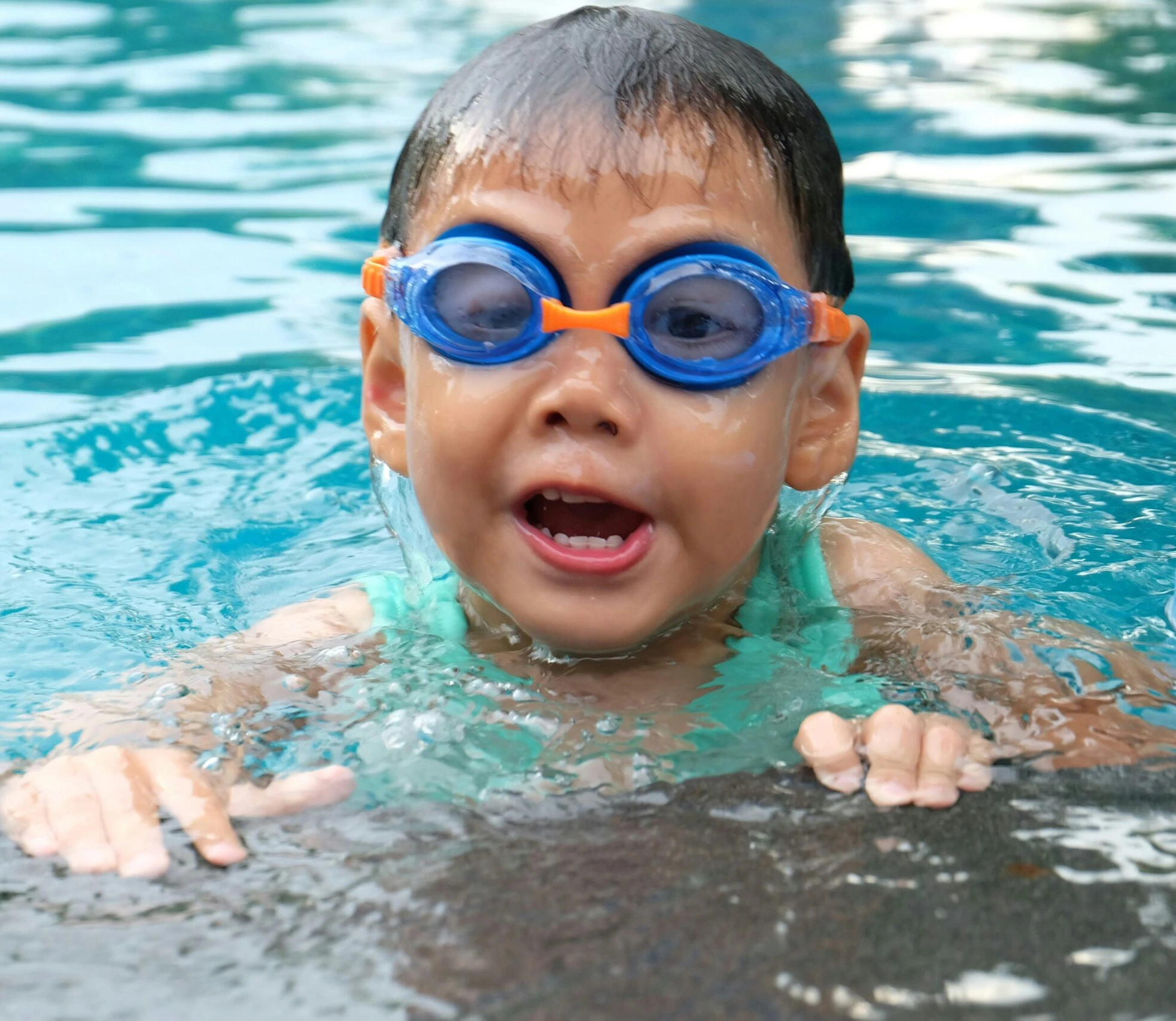 Swimming as a Life Skill , A young child learning to swim in a pool with a supportive instructor, focusing on safety and building confidence in the water.