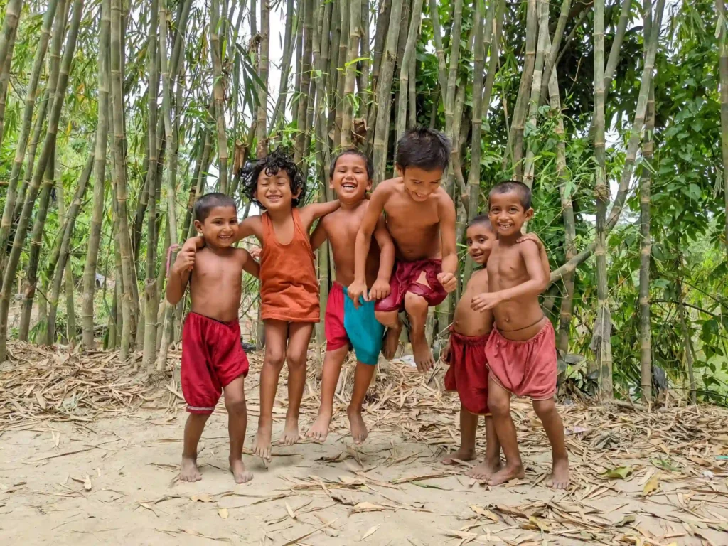 A diverse group of children playing outside in a green, safe, and healthy environment, highlighting the importance of environmental justice in child welfare.